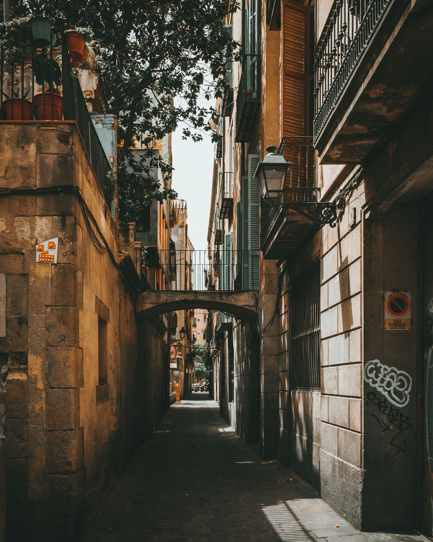 A narrow lane between old stone buildings in Barcelona's Gothic quarter